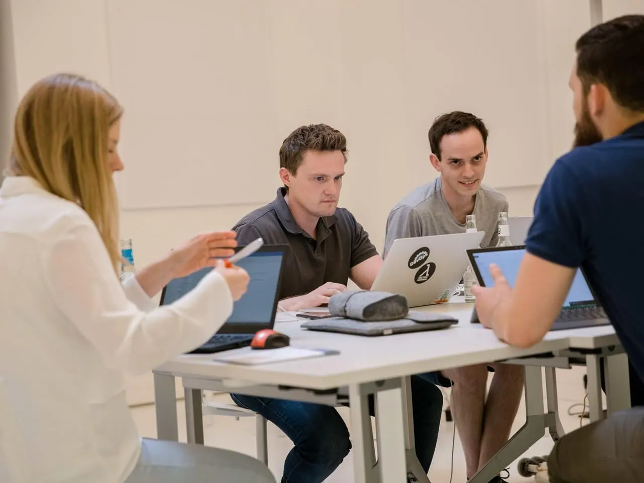 A product and engineering team collaborating around laptops